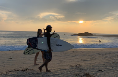 Happy surfers at sunset